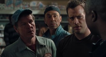 Movie still from “The Mist” (2007), directed by Frank Darabont – A group of men standing next to each other in a room; Close Up shot, Over the shoulder angle
