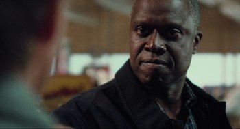 Movie still from “The Mist” (2007), directed by Frank Darabont – A person wearing a black shirt; Close Up shot, Over the shoulder angle