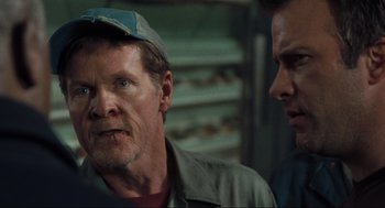 Movie still from “The Mist” (2007), directed by Frank Darabont – A man and a man standing next to each other in a kitchen; Close Up shot, Over the shoulder angle