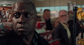 Movie still from “The Mist” (2007), directed by Frank Darabont – A group of people sitting in front of a window; Close Up shot, Over the shoulder angle