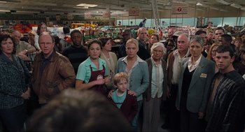 Movie still from “The Mist” (2007), directed by Frank Darabont – A group of people standing in a grocery store; Wide shot, High angle