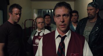 Movie still from “The Mist” (2007), directed by Frank Darabont – A group of men standing next to each other in a room; Medium shot, Over the shoulder angle