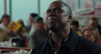 Movie still from “The Mist” (2007), directed by Frank Darabont – An older man looking up into the sky; Close Up shot, Low angle