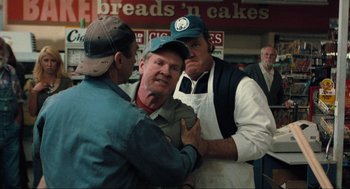 Movie still from “The Mist” (2007), directed by Frank Darabont – A group of men standing next to each other in a store; Medium shot, Over the shoulder angle