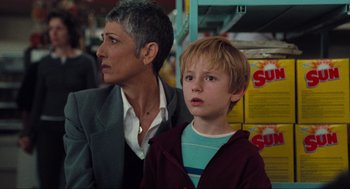Movie still from “The Mist” (2007), directed by Frank Darabont – A woman and a boy are looking at something in a store; Close Up shot, Over the shoulder angle