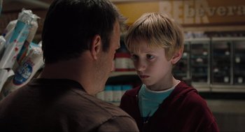 Movie still from “The Mist” (2007), directed by Frank Darabont – A man and a boy face each other in a store; Close Up shot, Over the shoulder angle