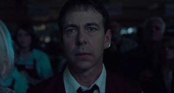 Movie still from “The Mist” (2007), directed by Frank Darabont – A person wearing a suit and tie; Close Up shot, Low angle