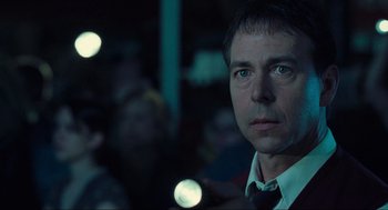 Movie still from “The Mist” (2007), directed by Frank Darabont – A person wearing a suit and tie; Close Up shot, Low angle