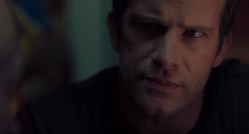 Movie still from “The Mist” (2007), directed by Frank Darabont – A man's face in a dark room; Close Up shot, Over the shoulder angle