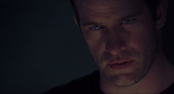 Movie still from “The Mist” (2007), directed by Frank Darabont – A person's face in the dark; Extreme Close Up shot, Low angle