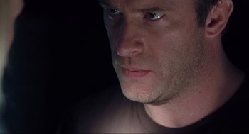 Movie still from “The Mist” (2007), directed by Frank Darabont – A man's face in the dark; Close Up shot, Low angle