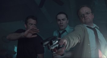 Movie still from “The Mist” (2007), directed by Frank Darabont – A group of men holding guns in a dark room; Medium shot, Over the shoulder angle