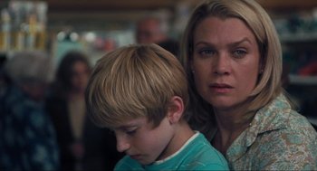 Movie still from “The Mist” (2007), directed by Frank Darabont – A woman and a boy looking at the camera; Close Up shot, Over the shoulder angle