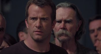 Movie still from “The Mist” (2007), directed by Frank Darabont – A man and a man with long hair and a mustache; Close Up shot, Over the shoulder angle