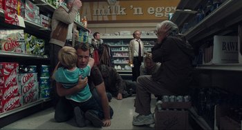 Movie still from “The Mist” (2007), directed by Frank Darabont – A group of people sitting around in a grocery store; Wide shot, High angle