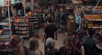 Movie still from “The Mist” (2007), directed by Frank Darabont – A group of people standing around a store; Wide shot, High angle