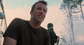 Movie still from “The Mist” (2007), directed by Frank Darabont – A man with a bandage on his face is looking at the camera; Close Up shot, Low angle