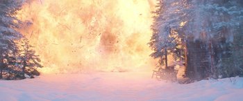 Movie still from “The Mother” (2023), directed by Niki Caro – An image of an explosion in the snow; Extreme Wide shot, High angle