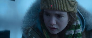 Movie still from “The Mother” (2023), directed by Niki Caro – A person wearing a hat; Close Up shot, Over the shoulder angle