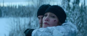 Movie still from “The Mother” (2023), directed by Niki Caro – A man and a woman in the snow; Close Up shot, Low angle
