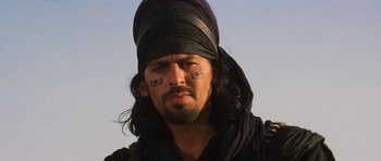 Movie still from “The Mummy” (1999), directed by Stephen Sommers – A person wearing a hat and face paint; Close Up shot, Low angle