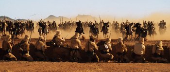 Movie still from “The Mummy” (1999), directed by Stephen Sommers – A group of men on horseback in a field; Extreme Wide shot, High angle