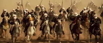 Movie still from “The Mummy” (1999), directed by Stephen Sommers – A group of men riding on the backs of white horses; Wide shot, High angle