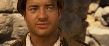 Movie still from “The Mummy” (1999), directed by Stephen Sommers – A man's face in a tan jacket; Close Up shot, Over the shoulder angle