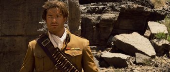 Movie still from “The Mummy” (1999), directed by Stephen Sommers – A man with a gun strapped to his shoulder; Medium shot, Low angle