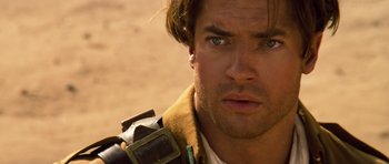 Movie still from “The Mummy” (1999), directed by Stephen Sommers – Close up of a man's face with a brown jacket on; Close Up shot, Over the shoulder angle
