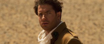 Movie still from “The Mummy” (1999), directed by Stephen Sommers – A person wearing a jacket; Close Up shot, Low angle