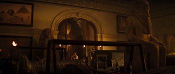 Movie still from “The Mummy” (1999), directed by Stephen Sommers – Two people are sitting in a living room; Extreme Wide shot, Over the shoulder angle