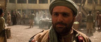 Movie still from “The Mummy” (1999), directed by Stephen Sommers – A person wearing a turban; Close Up shot, Over the shoulder angle