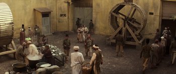 Movie still from “The Mummy” (1999), directed by Stephen Sommers – A group of men standing next to each other in a courtyard; Wide shot, High angle