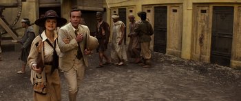 Movie still from “The Mummy” (1999), directed by Stephen Sommers – A group of men standing in a street; Medium shot, Over the shoulder angle