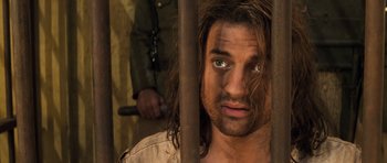 Movie still from “The Mummy” (1999), directed by Stephen Sommers – A person in a jail cell; Close Up shot, Over the shoulder angle
