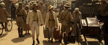 Movie still from “The Mummy” (1999), directed by Stephen Sommers – A group of people walking down a street with suitcases; Wide shot, High angle