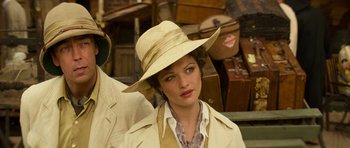Movie still from “The Mummy” (1999), directed by Stephen Sommers – A woman wearing a hat standing in front of suitcases; Close Up shot, Over the shoulder angle