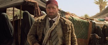 Movie still from “The Mummy” (1999), directed by Stephen Sommers – A man wearing a hat and a tie; Medium shot, Low angle