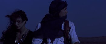 Movie still from “The Mummy” (1999), directed by Stephen Sommers – A man wearing a head scarf and a white shirt; Medium shot, Low angle