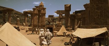 Movie still from “The Mummy” (1999), directed by Stephen Sommers – A group of people standing in front of a building; Extreme Wide shot, Low angle