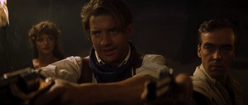 Movie still from “The Mummy” (1999), directed by Stephen Sommers – A man with a gun in his hand; Close Up shot, Over the shoulder angle