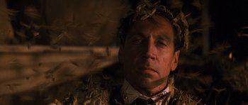 Movie still from “The Mummy” (1999), directed by Stephen Sommers – A person wearing a wreath of leaves; Close Up shot, Low angle