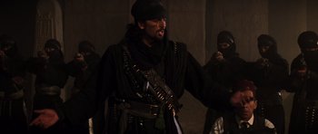 Movie still from “The Mummy” (1999), directed by Stephen Sommers – A man wearing a black outfit and a black hat; Medium shot, Over the shoulder angle