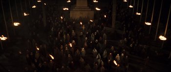 Movie still from “The Mummy” (1999), directed by Stephen Sommers – A group of people standing in a dark room with torches; Extreme Wide shot, High angle