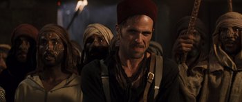 Movie still from “The Mummy” (1999), directed by Stephen Sommers – A group of men standing next to each other; Close Up shot, Over the shoulder angle