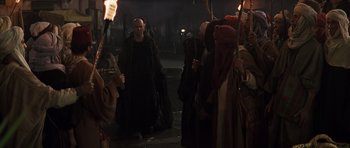 Movie still from “The Mummy” (1999), directed by Stephen Sommers – A group of people dressed in medieval clothing; Wide shot, Over the shoulder angle