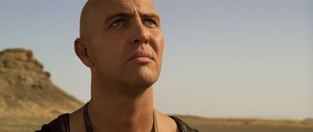 Movie still from “The Mummy” (1999), directed by Stephen Sommers – A man with a bald head looking up into the sky; Close Up shot, Low angle