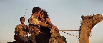 Movie still from “The Mummy” (1999), directed by Stephen Sommers – A man and a woman sitting on top of a boat; Wide shot, Low angle
