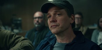 Movie still from “Dopesick” (2021), directed by Danny Strong – A person wearing a hat; Close Up shot, Over the shoulder angle